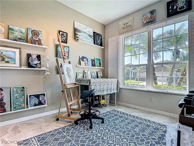 a view of a workspace with furniture and a window