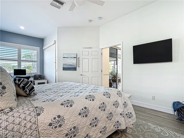 a bedroom with a bed and a flat screen tv
