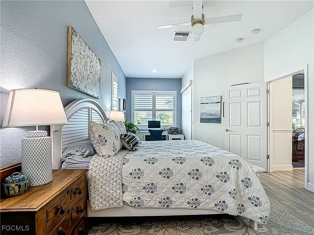 a bedroom with a large bed and a lamp