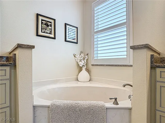 a bathroom with a tub and a shower