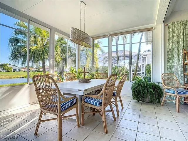 a dining room with furniture water view and balcony