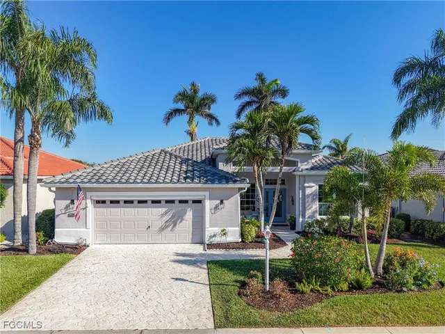 front view of house with potted plants and palm trees