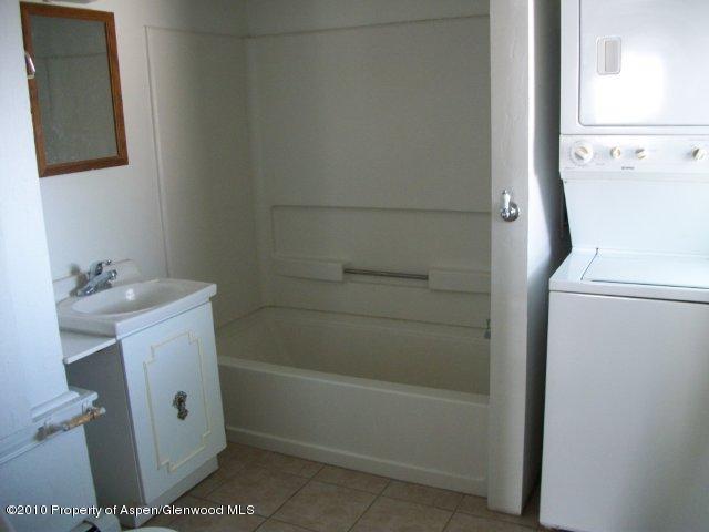 303 East 3rd Street Rifle, CO 81650 - Photo 4 of 8 a bathroom with a sink a toilet and shower