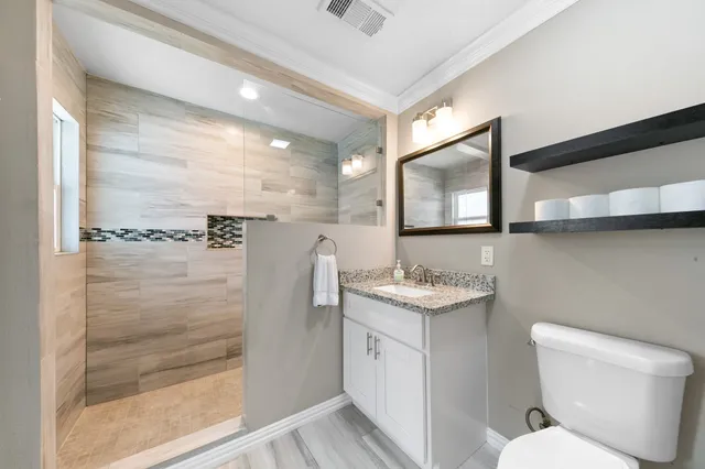 a bathroom with a toilet sink and shower