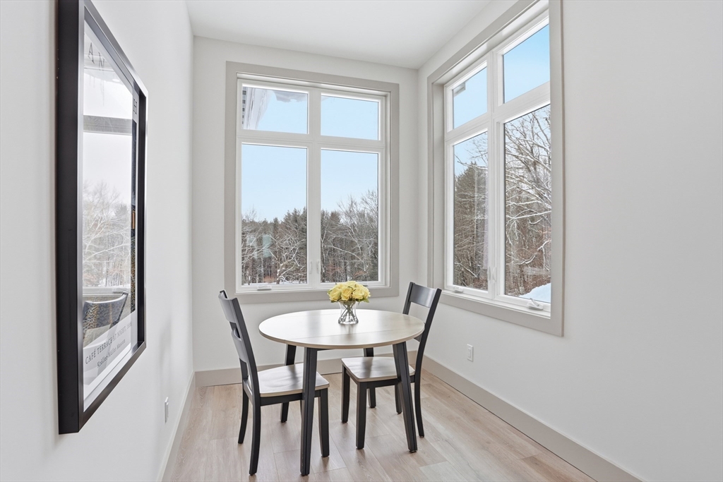 235 Kemp Street Dunstable, MA 01827 - Photo 13 of 42 a dining room with furniture large windows and a chandelier