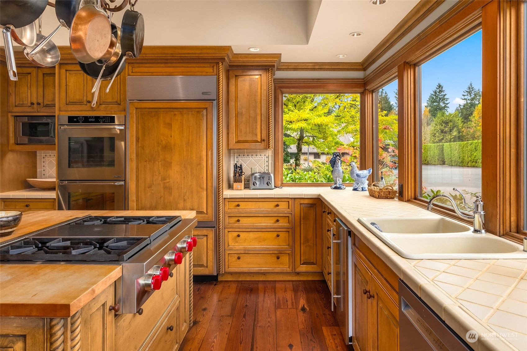 12011 Southwest 220th Street Vashon, WA 98070 - Photo 19 of 40 a kitchen that has a sink stove and a wooden floor