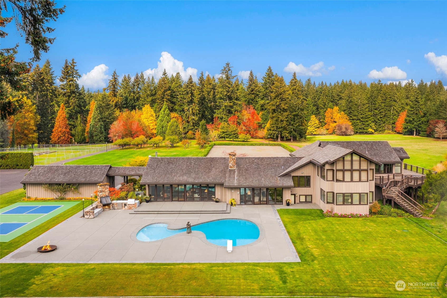 12011 Southwest 220th Street Vashon, WA 98070 - Photo 2 of 40 a view of a house with swimming pool and a yard