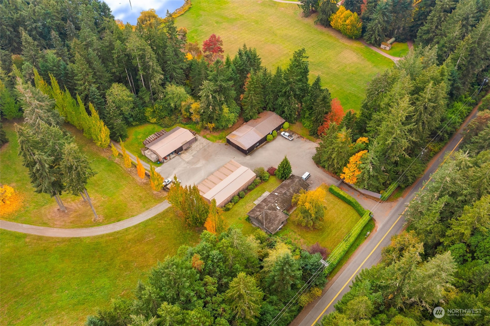 12011 Southwest 220th Street Vashon, WA 98070 - Photo 37 of 40 an aerial view of a house with swimming pool and trees in the background