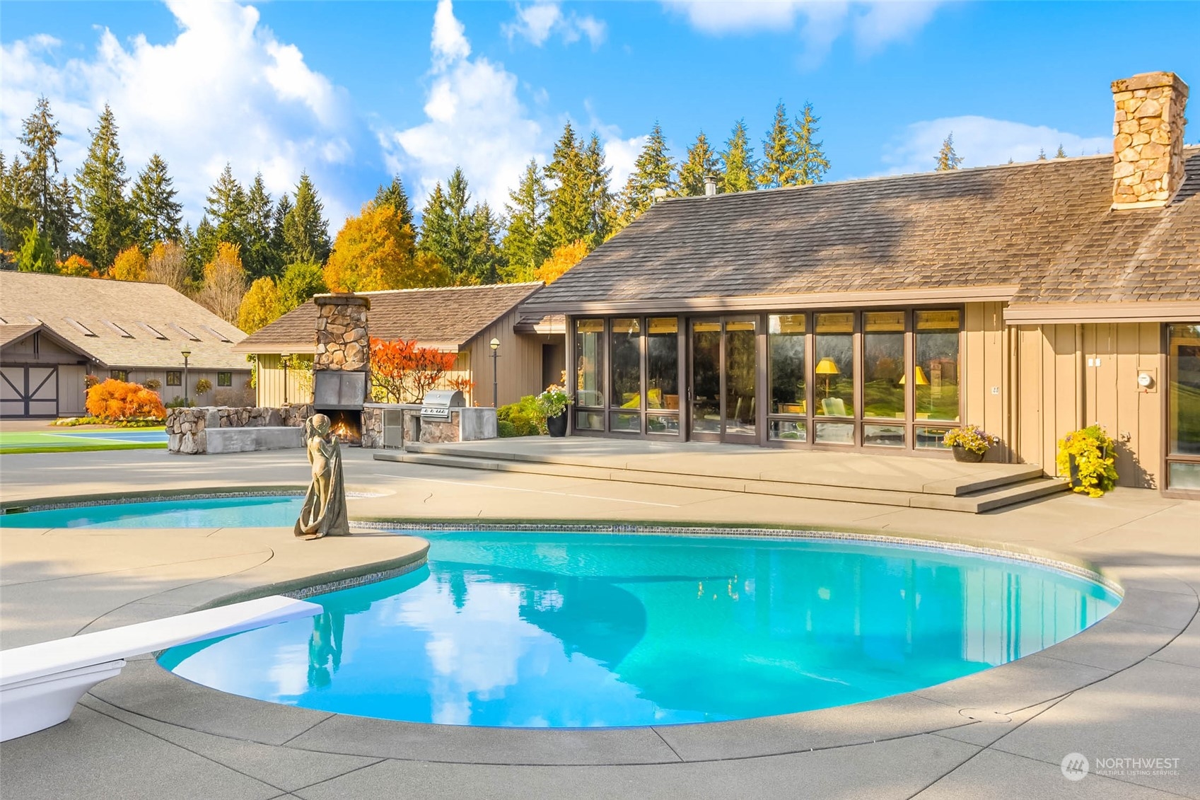 12011 Southwest 220th Street Vashon, WA 98070 - Photo 6 of 40 a view of swimming pool with outdoor seating and house in the background