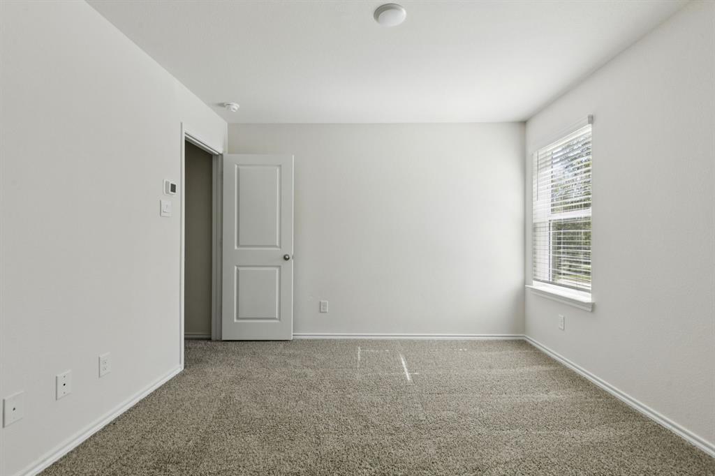 317 Clematis Street Princeton, TX 75407 - Photo 20 of 38 Carpeted empty room featuring baseboards