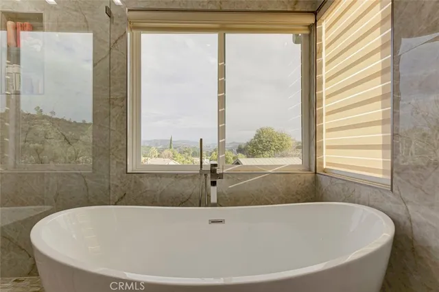 a front view of a house with a yard and lake view