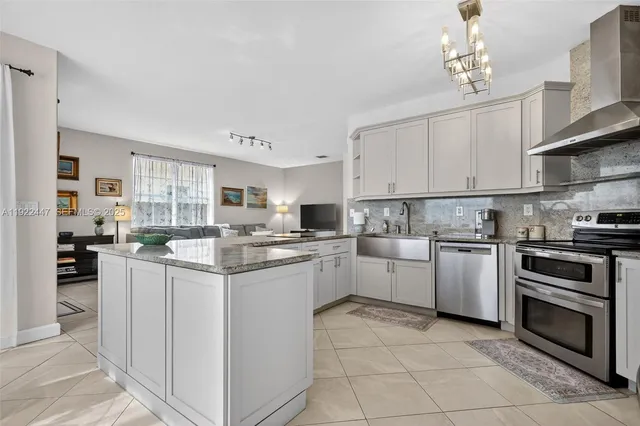 a kitchen with white cabinets and appliances