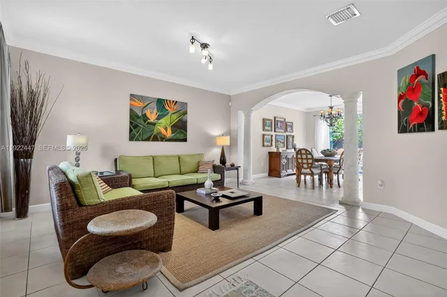 a living room with furniture a rug and a window