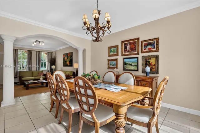 a kitchen with granite countertop white cabinets white appliances a sink and a counter top space