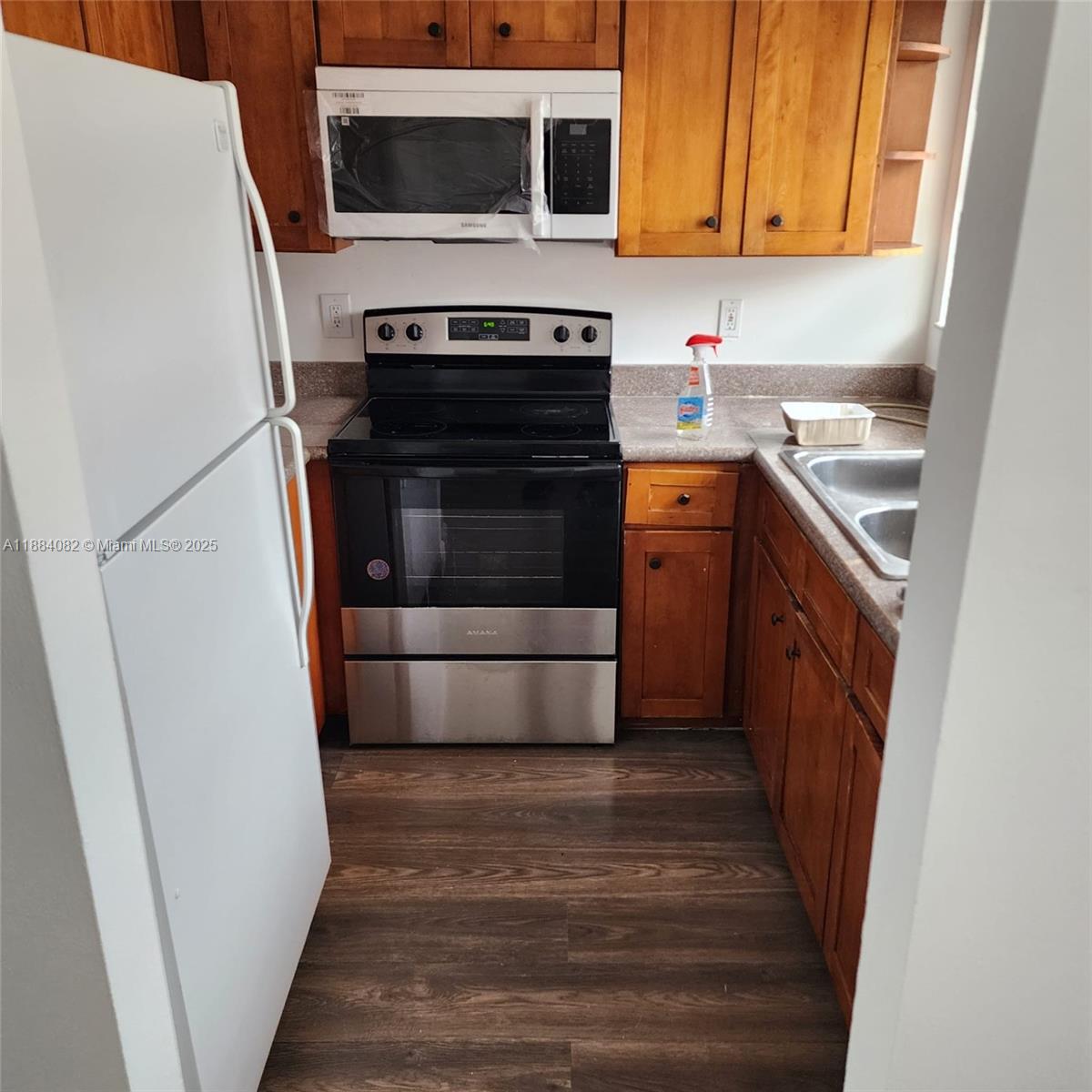 a kitchen with a stove microwave and refrigerator