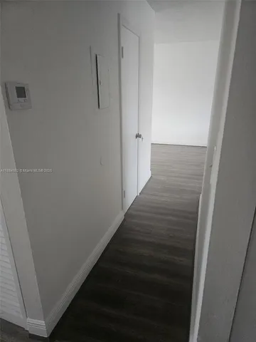 a view of hallway with wooden floor