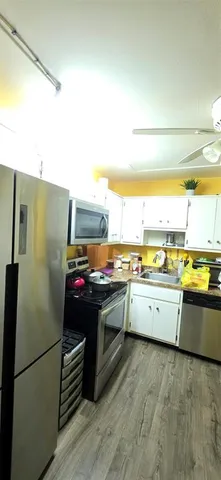a kitchen with a refrigerator and a stove