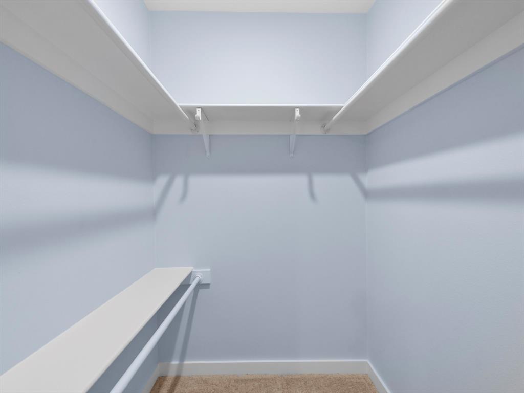 2033 Lymington Road Carrollton, TX 75007 - Photo 22 of 33 Primary Bedroom-Built-in shelving and hanging rods