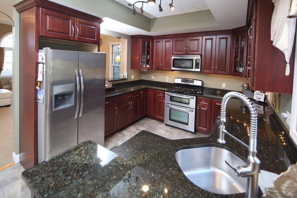 40 Lazel Street Whitman, MA 02382 - Photo 7 of 20 a kitchen with stainless steel appliances granite countertop a sink refrigerator and microwave