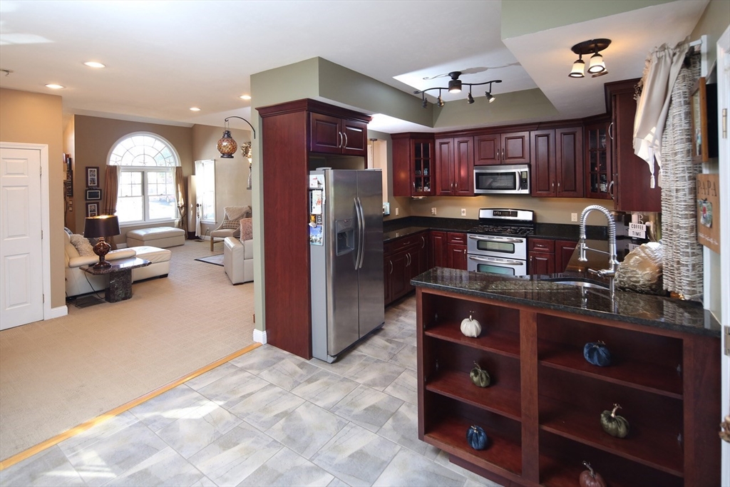 40 Lazel Street Whitman, MA 02382 - Photo 8 of 20 a kitchen view with stainless steel appliances kitchen island granite countertop a refrigerator and a stove top oven