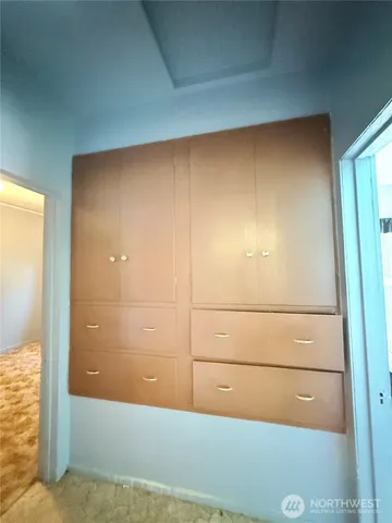 a bed sitting in a bedroom next to a window