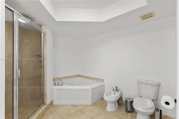 a white toilet sitting next to a bathroom sink