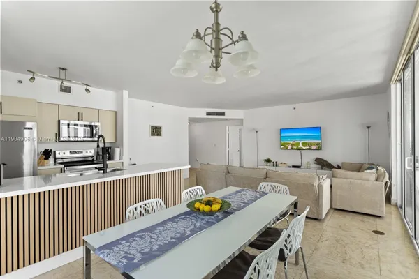 a living room with furniture and a dining table