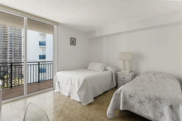 a bedroom with two beds and a window