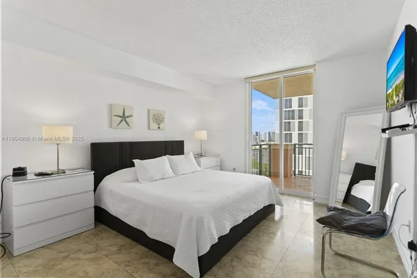 a bedroom with a bed and a flat screen tv