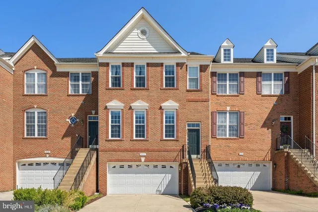 a view of a brick house with large windows
