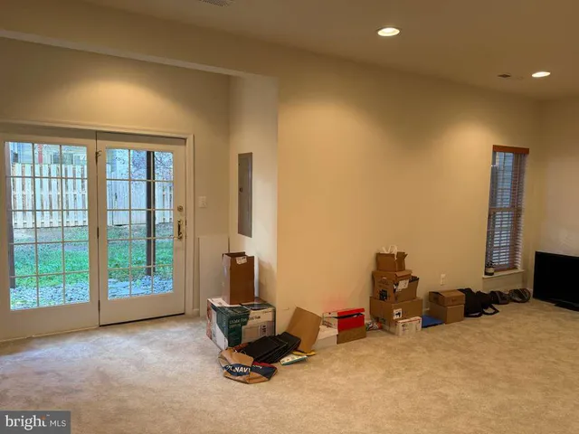 a living room with furniture a flat screen tv and a large window