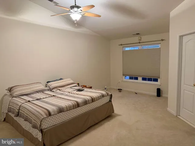 a bedroom with a bed and a flat tv screen