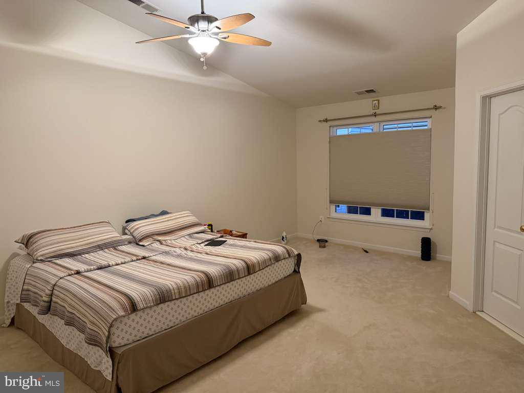25210 Whippoorwill Terrace Chantilly, VA 20152 - Photo 20 of 33 a bedroom with a bed and a flat tv screen