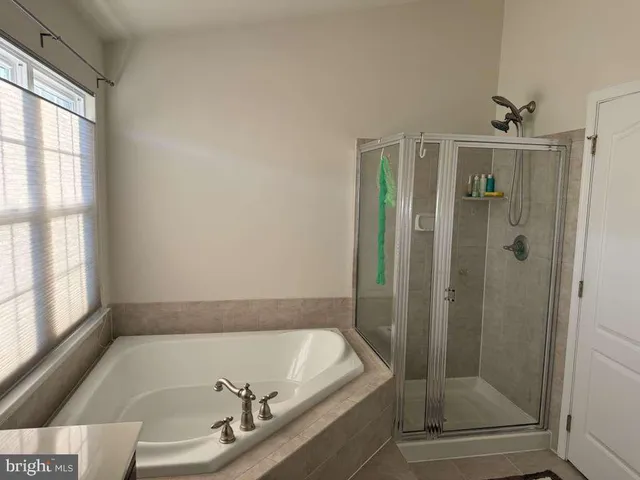 a bathroom with a tub and shower