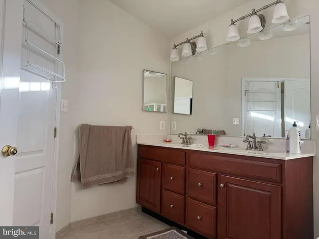 a bathroom with a sink vanity and mirror