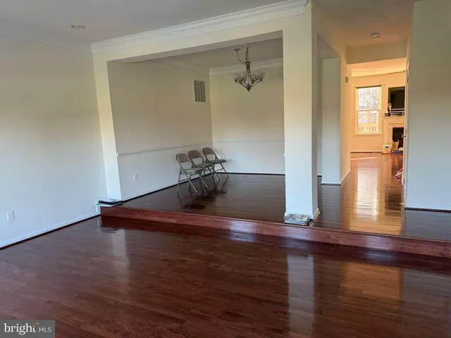 a view of a room with wooden floor