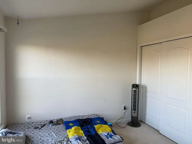 a small space with a bed and a window