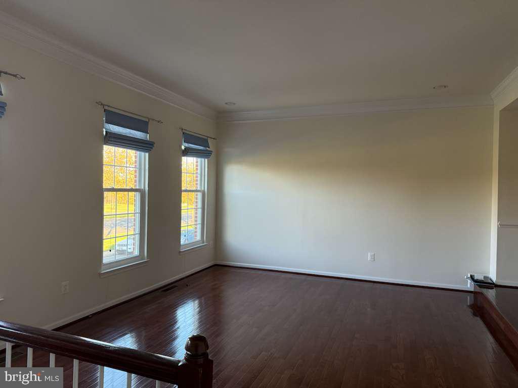 25210 Whippoorwill Terrace Chantilly, VA 20152 - Photo 4 of 33 a view of a room with wooden floor and windows
