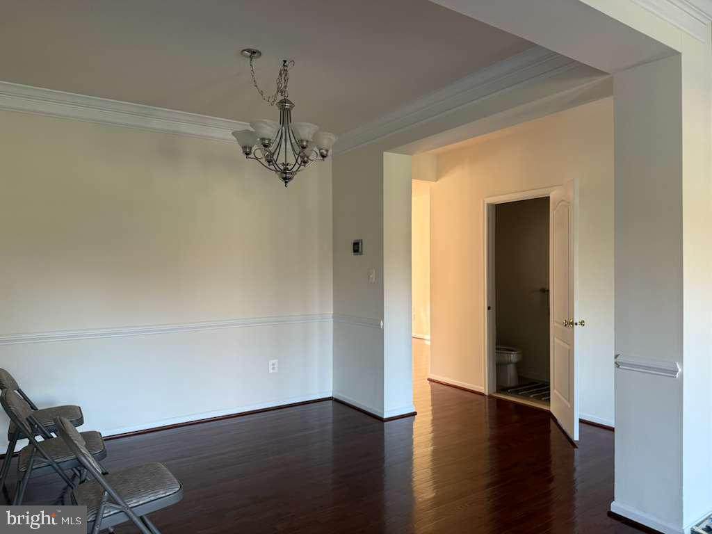 25210 Whippoorwill Terrace Chantilly, VA 20152 - Photo 7 of 33 a view of a room with wooden floor air conditioner and windows