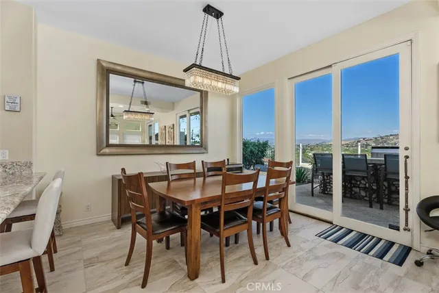 a dining room with furniture a rug and a painting