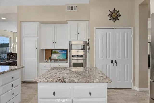 a kitchen with appliances cabinets and a counter top space