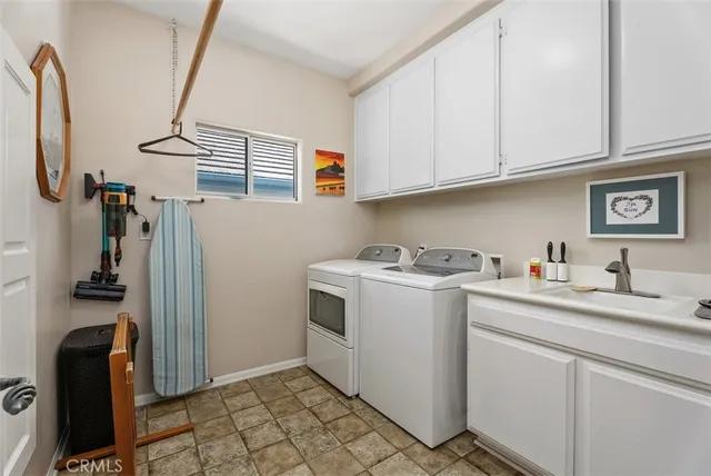a view of a storage and utility room with two washing machine