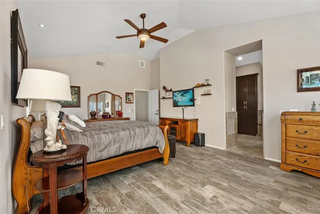 a bedroom with a bed and a lamp on table