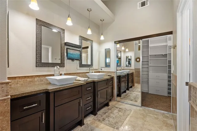 a bathroom with a granite countertop sink mirror and double