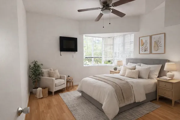 a bedroom with a bed and a flat screen tv