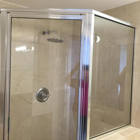 a bathroom with a glass shower door