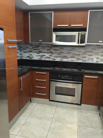 a kitchen with stainless steel appliances granite countertop a stove and a sink
