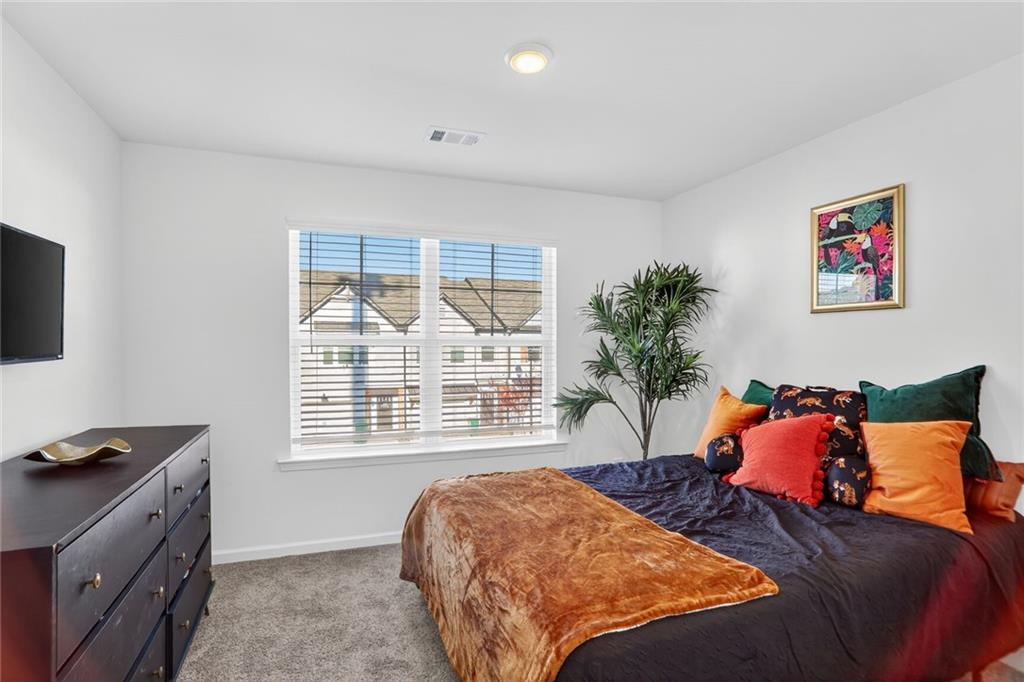 4125 Spring Valley Circle, Unit 7 Tucker, GA 30084 - Photo 11 of 20 a bedroom with a bed and a window