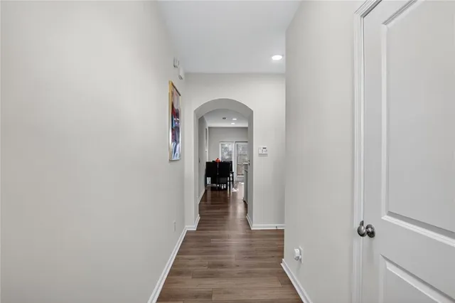 a view of a hallway view with wooden floor and staircase