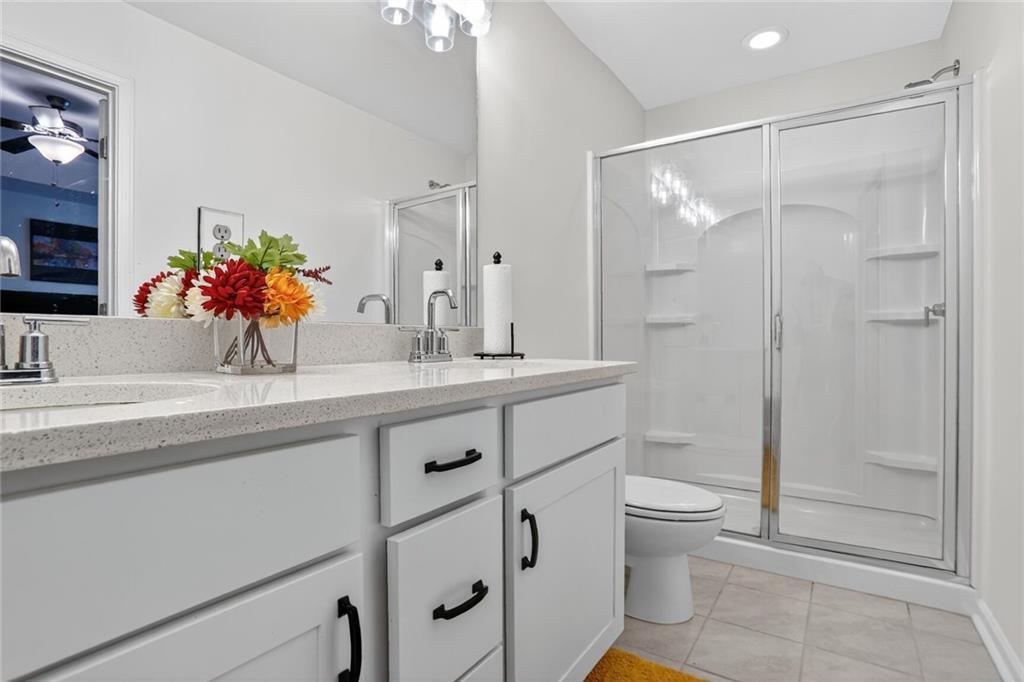 4125 Spring Valley Circle, Unit 7 Tucker, GA 30084 - Photo 16 of 20 a bathroom with a shower sink vanity mirror and toilet